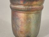 a silver cup that is sitting on a table