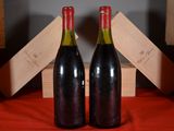 two bottles of wine sitting next to each other on a table