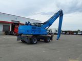 a blue crane that is parked in a parking lot