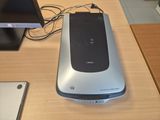 a cell phone sitting on top of a desk next to a monitor