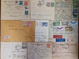 several old envelopes are sitting on a table with stamps on them