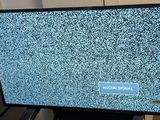 a television that is sitting on a stand in the kitchen
