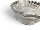 a glass bowl with a spoon in it on a white surface