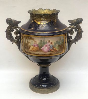 a vase with a painting on it sitting on a table