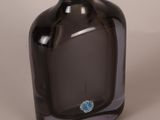 a black glass bottle with a blue flower on it