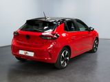 the rear end of a red car parked in a room