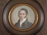 portrait of a man in a suit and tie in a wooden frame