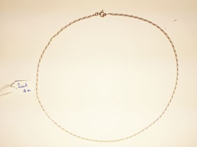 a drawing of a necklace on a table with a pen