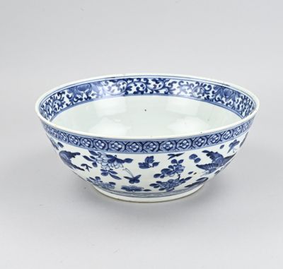 a blue and white bowl with a floral design on the rim