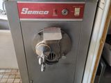 a machine that is sitting on the floor in the kitchen