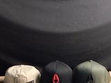 many hats and cell phones sitting on a table
