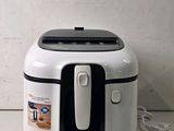 a white and black air fryer sitting on a counter