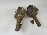 two antique brass fire hydrants on a white background