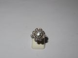 a close up of a diamond ring on a white surface