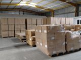 a large warehouse with a lot of boxes and pallets