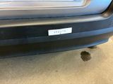 a car that has a sticker on it ' s bumper