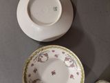 two cups and a saucer sitting on a table