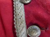 a close up of a red coat with buttons on it