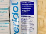 a bottle of toothpaste sitting on top of a stack of boxes