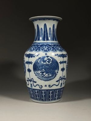 a blue and white vase with a bird on it