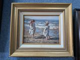 painting of two children playing on the beach in a gold frame