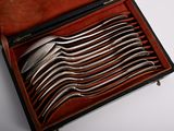 a lot of spoons in a case on the table