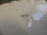 a close up of a white plate with a green design on it
