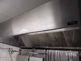 a large stainless steel exhaust hood in a commercial kitchen