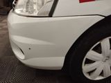 a close up of a white car with a red stripe on it