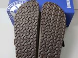 the soles of a pair of shoes are shown in front of a blue box