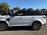 a white land rover parked in a parking lot