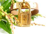 a gold watch with a lock on a brown leather bracelet