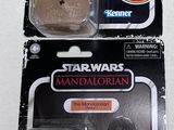 two star wars action figures are shown on a white surface