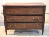 a wooden chest of drawers on display in a room