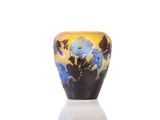 a vase that is sitting on a table with a white base