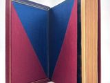 a book open to show a blue and red cover