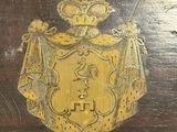 an image of a wooden table with a gold emblem on it