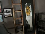 a ladder leaning up against a mirror in a living room