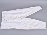 an old pair of white pants sitting on top of a gray surface