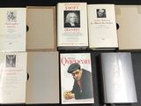 several books are stacked on top of each other on a table