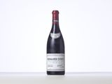 a bottle of red wine sitting on top of a table