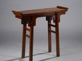 an image of a small wooden table with two legs