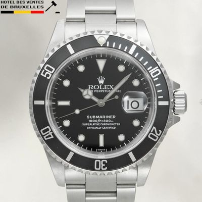 a close up of a watch with a black dial on a bracelet