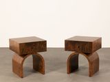 a pair of wooden stools sitting on top of a cement floor