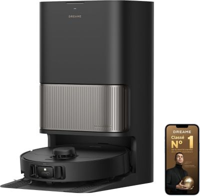 a close up of a coffee maker with a phone next to it