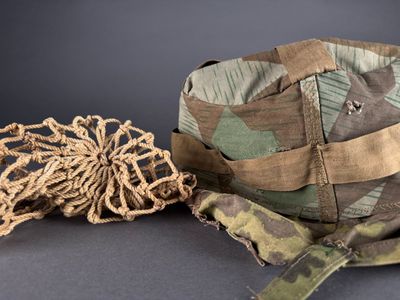 a camouflage hat and a rope on a table