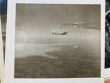 a picture of an old photo of a plane flying in the sky