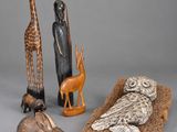 several different types of african figurines including a giraffe, an owl, and a bird
