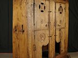 an old wooden cabinet with a door and a window