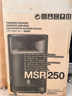 boxes of speakers are stacked on top of each other on a table